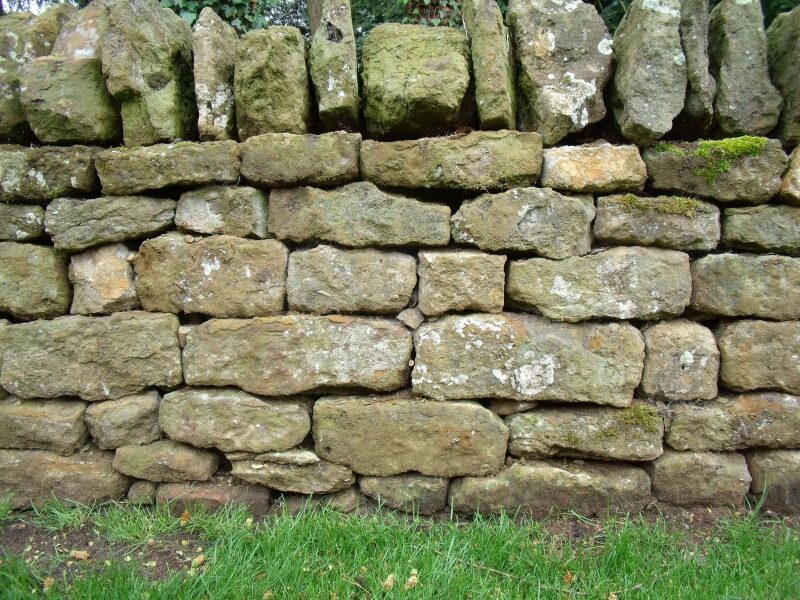 Close-up of rebuilt Hornton stone dry wall coursing with lichen