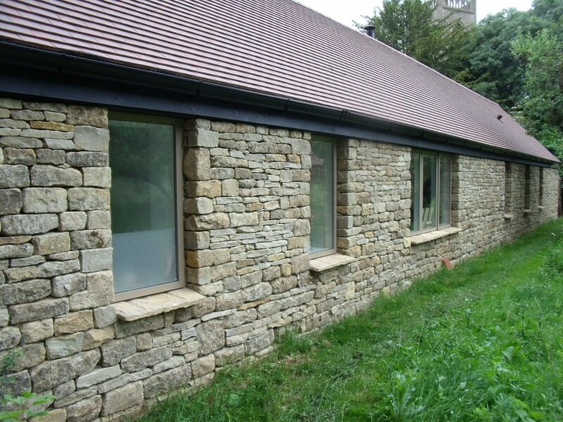 Restored stone dwelling at Heythrop with repaired stonework