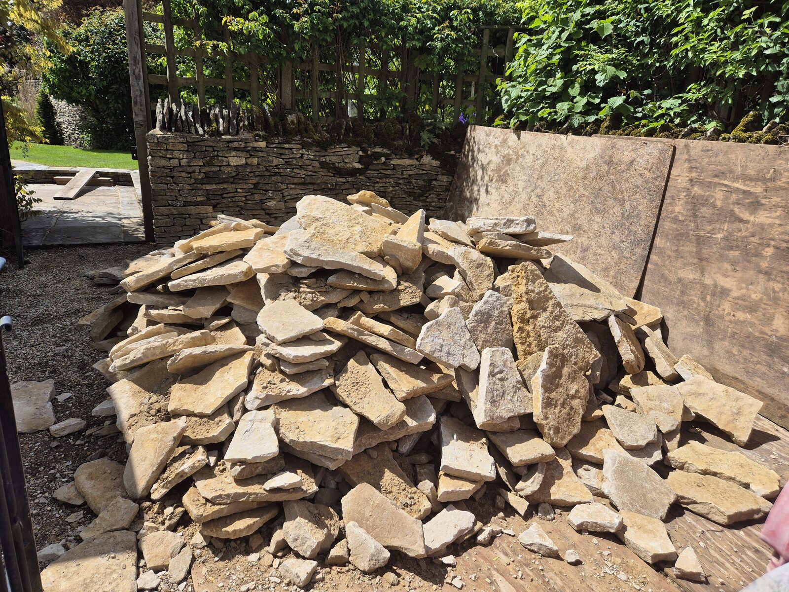 Sorted pile of reclaimed walling stone at the start of a rebuild
