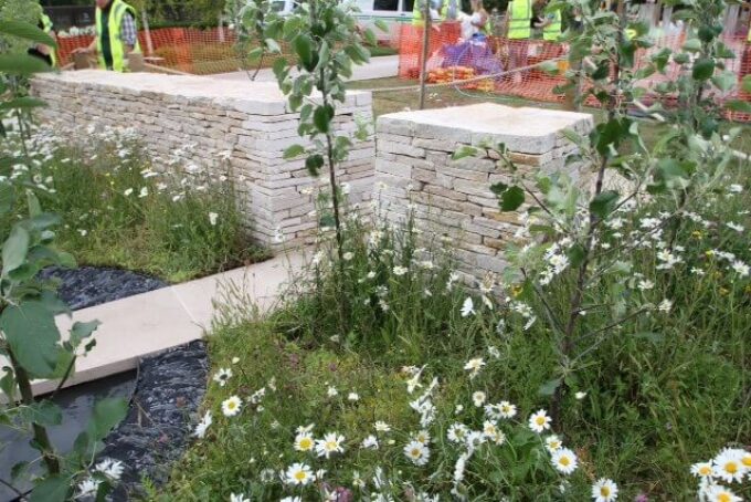 New dry stone garden walls with wildflower meadow planting