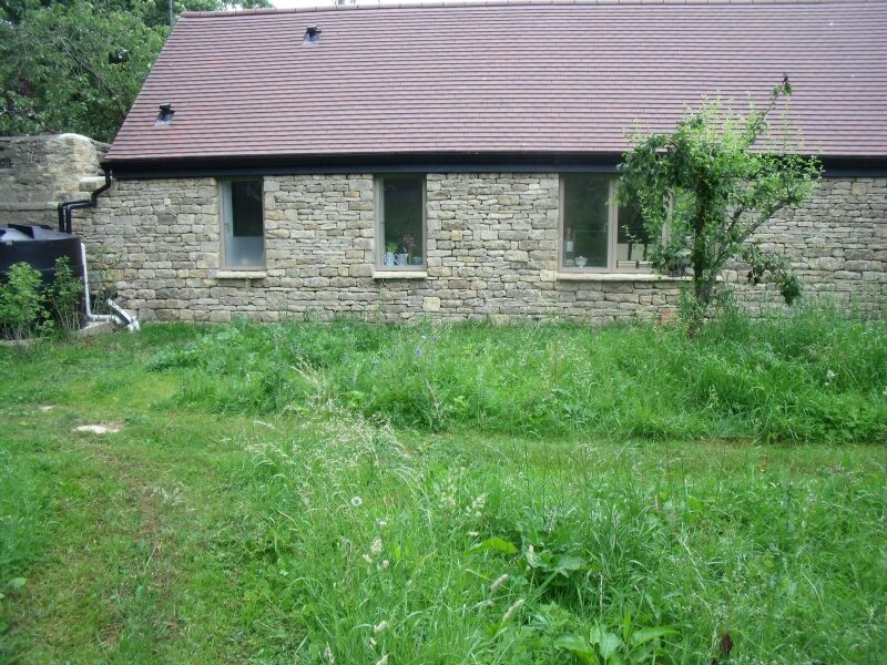 Dry stone cladding on modern SIPS panel dwelling